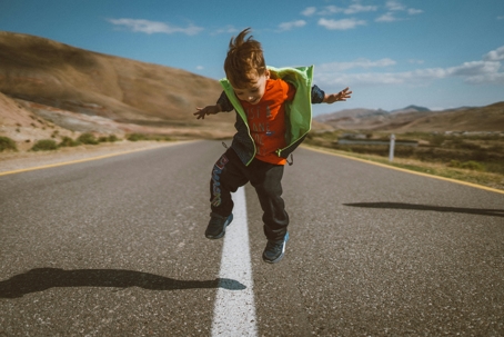 child jumping in street
