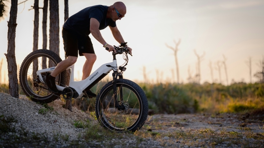 man in black shirt on an e-bike